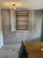 Chicargo Concrete fitted cupboards and drawer installed in a dining room (doors open), fitted in Billingham